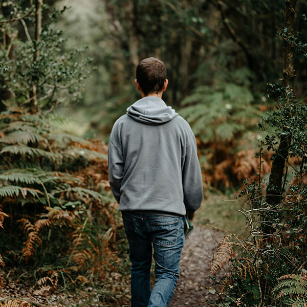 Photo Of Young Man Walking In Woods